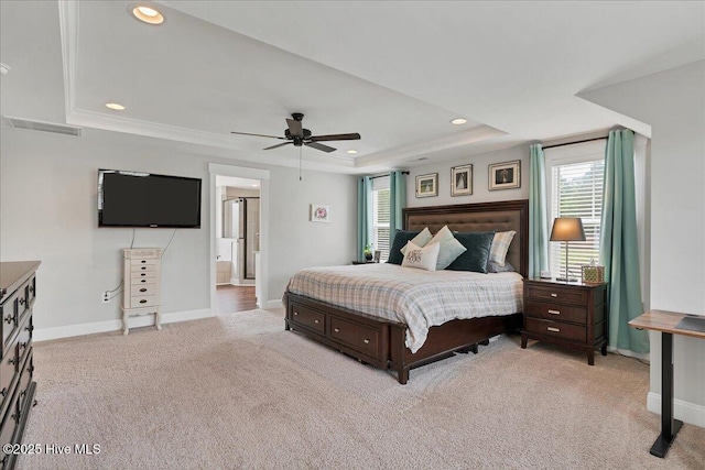 bedroom with a raised ceiling, light colored carpet, baseboards, multiple windows, and recessed lighting