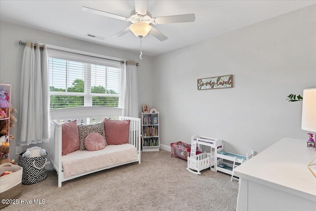 bedroom featuring light colored carpet, ceiling fan, and baseboards