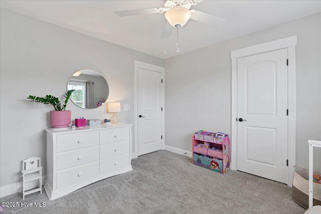 carpeted bedroom with baseboards and ceiling fan