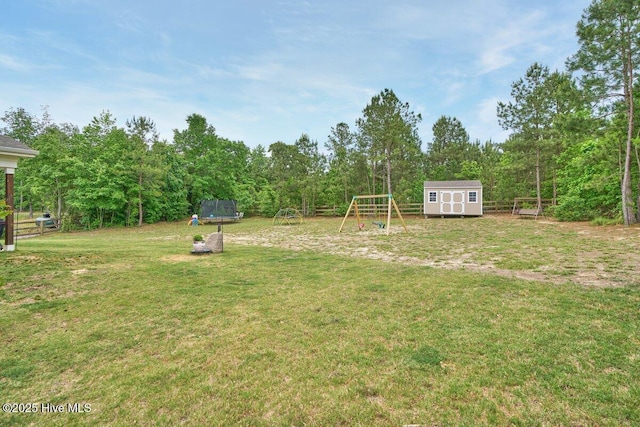 view of green lawn with a storage shed, an outbuilding, a playground, and a trampoline