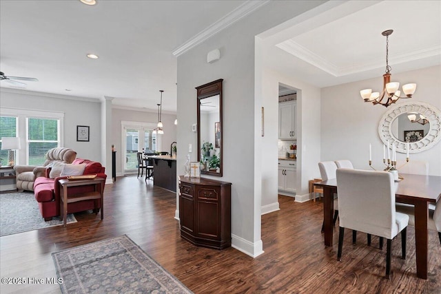 dining area featuring dark wood finished floors, a chandelier, ornamental molding, recessed lighting, and a ceiling fan