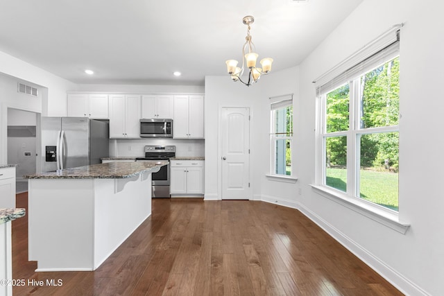 365 W Goldeneye Ln, Sneads Ferry, NC 28460 - unfurnished living room with ceiling fan, a chandelier, a glass covered fireplace, baseboards, and recessed lighting