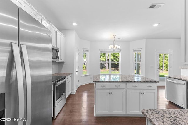 365 W Goldeneye Ln, Sneads Ferry, NC 28460 - kitchen featuring a sink, backsplash, a fireplace, dark wood-style flooring, and white cabinets