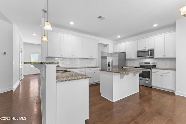 365 W Goldeneye Ln, Sneads Ferry, NC 28460 - kitchen with appliances with stainless steel finishes, healthy amount of natural light, white cabinetry, a chandelier, and recessed lighting