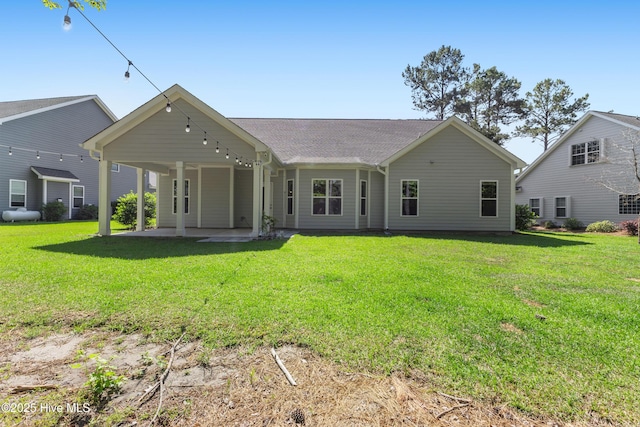 365 W Goldeneye Ln, Sneads Ferry, NC 28460 - rear view of house with a yard, a patio area, and roof with shingles