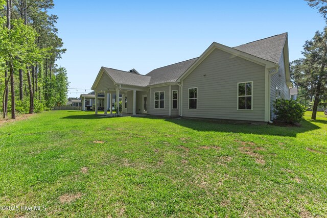 365 W Goldeneye Ln, Sneads Ferry, NC 28460 - back of property featuring a yard and a shingled roof
