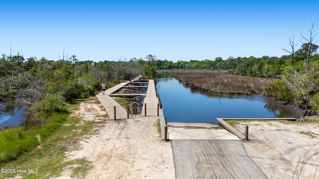 365 W Goldeneye Ln, Sneads Ferry, NC 28460 - dock with a boat ramp, a water view, and a view of trees