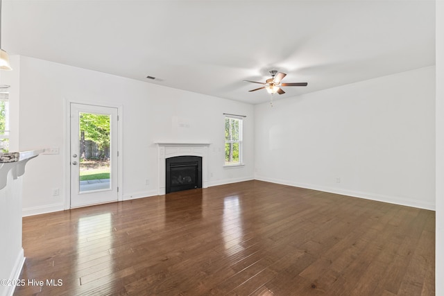 365 W Goldeneye Ln, Sneads Ferry, NC 28460 - unfurnished living room featuring ceiling fan, a glass covered fireplace, dark wood-type flooring, and baseboards