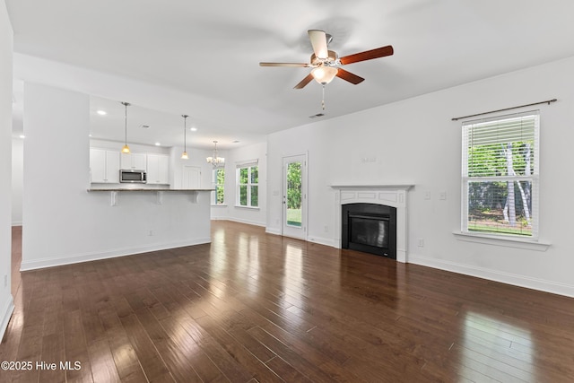 365 W Goldeneye Ln, Sneads Ferry, NC 28460 - unfurnished living room with a ceiling fan, a glass covered fireplace, baseboards, dark wood finished floors, and recessed lighting