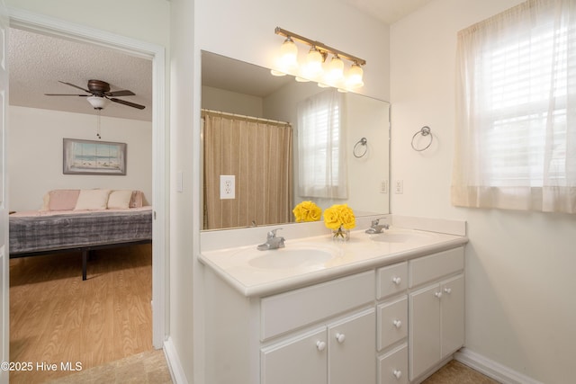 bathroom featuring double vanity, a wealth of natural light, and a sink