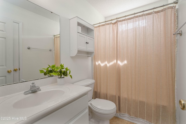 full bathroom featuring toilet, vanity, and a shower with shower curtain