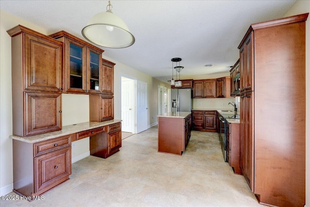 kitchen featuring appliances with stainless steel finishes, hanging light fixtures, a kitchen island, and baseboards
