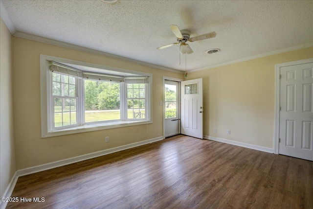 spare room with wood finished floors, a textured ceiling, a ceiling fan, crown molding, and baseboards