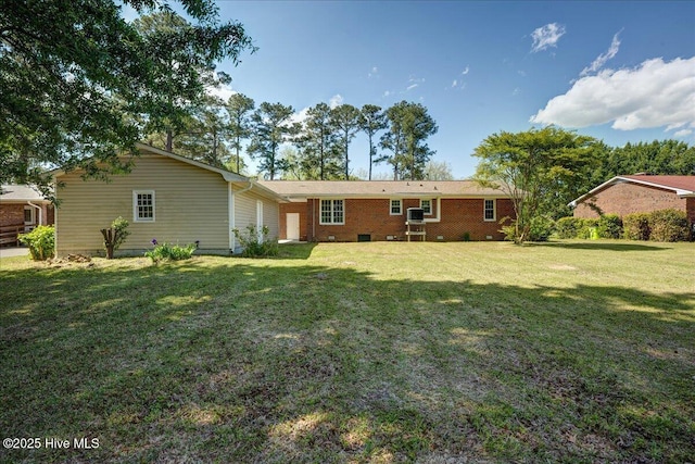 rear view of house featuring a yard