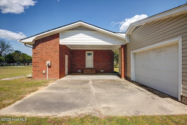 view of front facade featuring entry steps, brick siding, driveway, and a carport