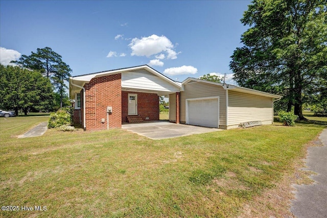 view of front facade featuring an outbuilding, a front lawn, a detached garage, and brick siding