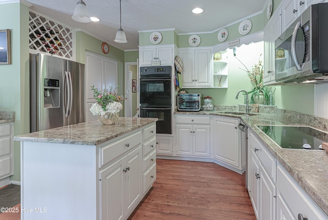 1 Collett Ln, Pinehurst, NC 28374 - kitchen featuring black appliances, a sink, light wood finished floors, white cabinets, and ornamental molding
