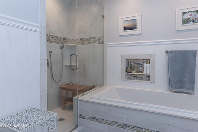 1 Collett Ln, Pinehurst, NC 28374 - bathroom featuring a shower stall, a bath, and a wainscoted wall