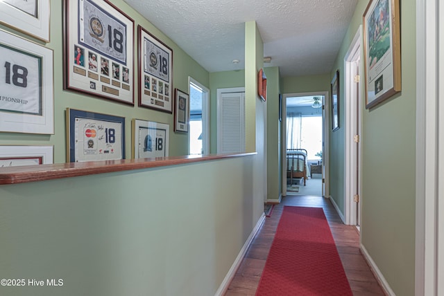 1 Collett Ln, Pinehurst, NC 28374 - hall featuring wood finished floors, baseboards, and a textured ceiling