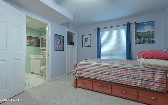 1 Collett Ln, Pinehurst, NC 28374 - bedroom featuring carpet flooring, ensuite bathroom, baseboards, and tile patterned floors