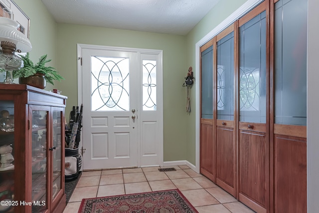 1 Collett Ln, Pinehurst, NC 28374 - foyer featuring light tile patterned floors and a textured ceiling