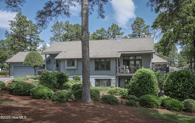 12 Shenecossett Ln, Pinehurst, NC 28374 - view of front of home with a balcony, roof with shingles, a garage, and a chimney