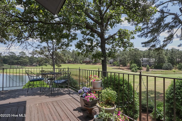 12 Shenecossett Ln, Pinehurst, NC 28374 - wooden deck featuring a lawn, a water view, and view of wooded area