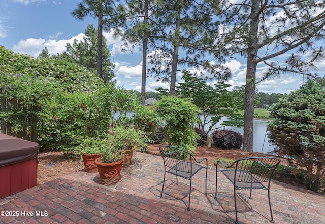 12 Shenecossett Ln, Pinehurst, NC 28374 - view of patio / terrace with a hot tub and a water view