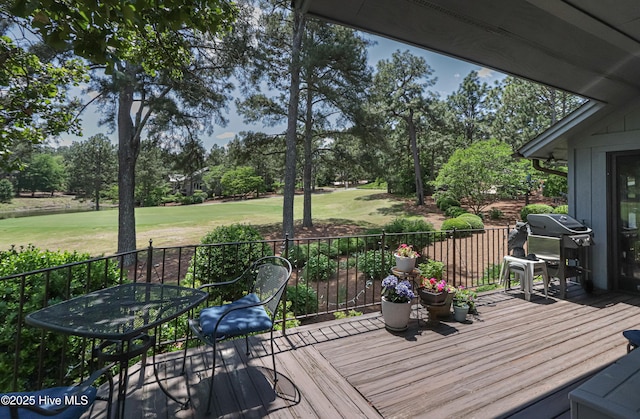 12 Shenecossett Ln, Pinehurst, NC 28374 - wooden terrace featuring area for grilling, view of wooded area, a yard, and golf course view