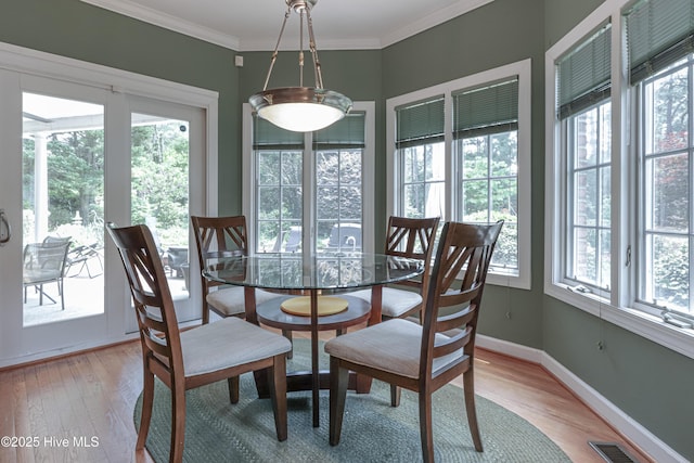 127 Sakonnet Trl, Pinehurst, NC 28374 - dining area featuring plenty of natural light, light wood-style floors, crown molding, and baseboards