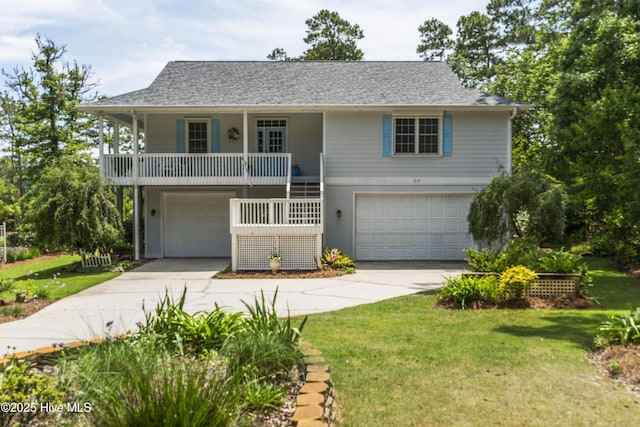 3243 Marsh View Dr SW, Supply, NC 28462 - view of front of home with an attached garage, concrete driveway, a front yard, and a porch
