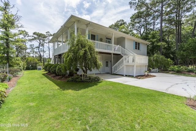 3243 Marsh View Dr SW, Supply, NC 28462 - rear view of property featuring driveway, a yard, stairway, and a porch