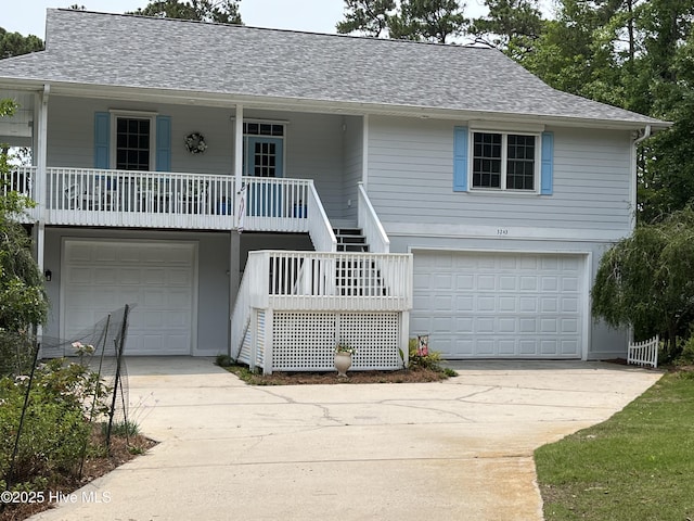 3243 Marsh View Dr SW, Supply, NC 28462 - raised beach house featuring an attached garage, stairs, covered porch, and a shingled roof