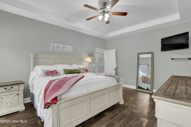 133 Fallbrook Ln, Rocky Point, NC 28457 - bedroom featuring a raised ceiling, dark wood finished floors, baseboards, and a ceiling fan