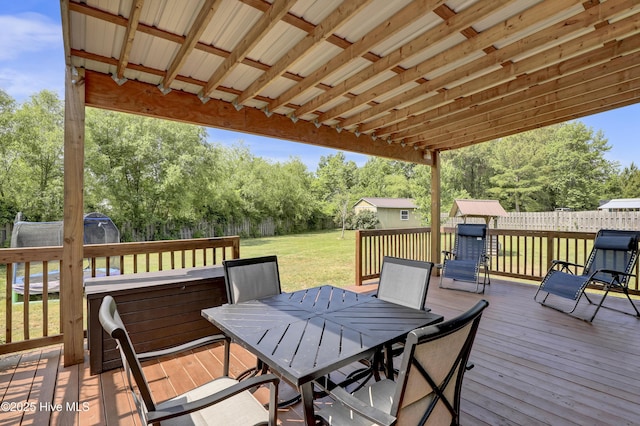 133 Fallbrook Ln, Rocky Point, NC 28457 - wooden terrace with a storage shed, outdoor dining space, an outdoor structure, and view of scattered trees