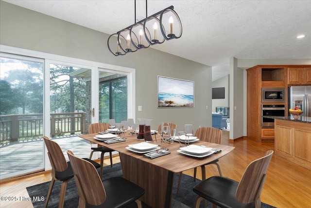 dining room with light wood-type flooring, a textured ceiling, a chandelier, and recessed lighting