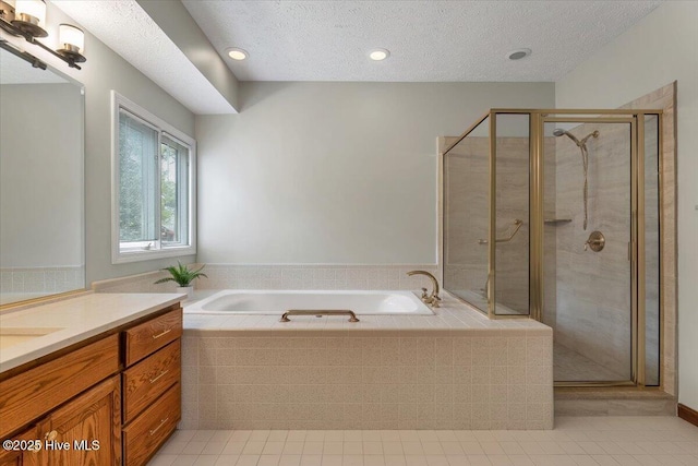 full bath with tile patterned floors, vanity, a stall shower, a bath, and a textured ceiling