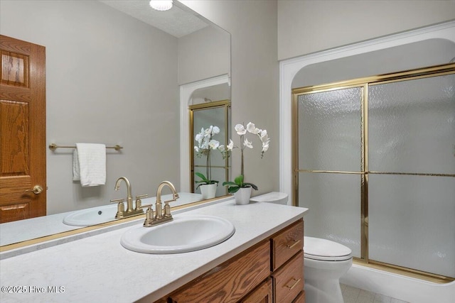 full bathroom with a stall shower, toilet, and vanity