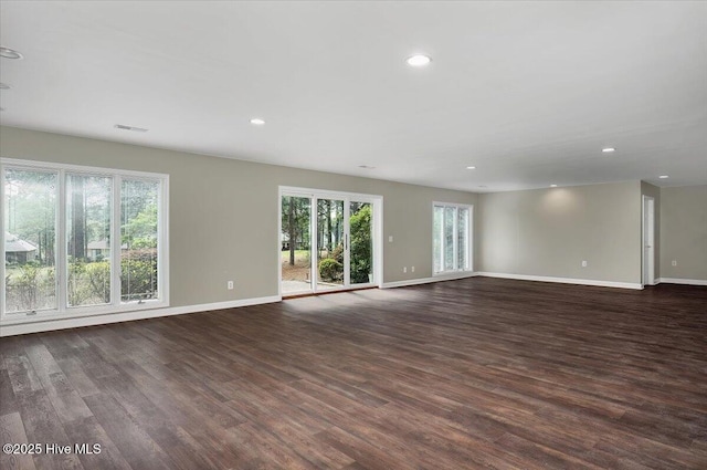 spare room with baseboards, dark wood-style floors, and recessed lighting