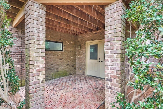 property entrance with brick siding