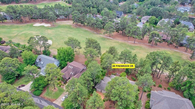 aerial view of property's location featuring nearby suburban area and a golf course