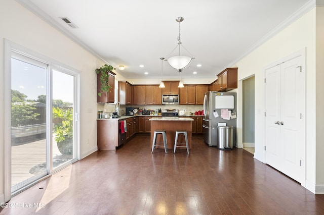 1427 Hammocks Beach Rd, Swansboro, NC 28584 - kitchen with stainless steel appliances, a kitchen island, tasteful backsplash, dark wood-style floors, and pendant lighting