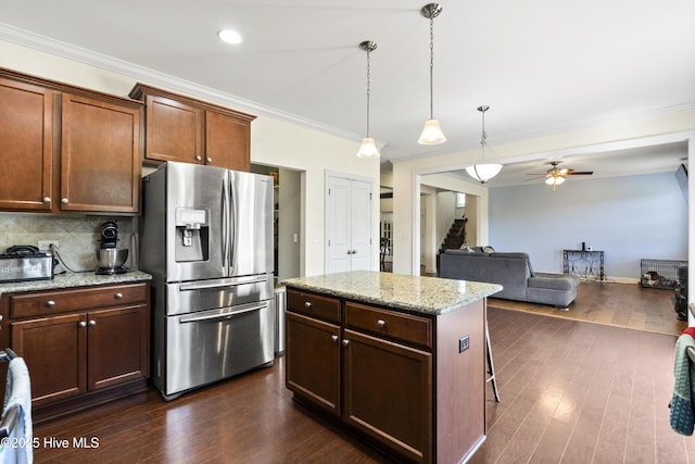 1427 Hammocks Beach Rd, Swansboro, NC 28584 - kitchen with stainless steel fridge with ice dispenser, a ceiling fan, pendant lighting, dark wood-style flooring, and ornamental molding