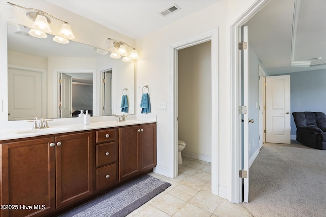 1427 Hammocks Beach Rd, Swansboro, NC 28584 - bathroom with toilet, double vanity, tile patterned flooring, and baseboards