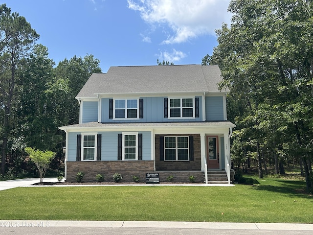 738 Hollybriar Loop Rd SE, Bolivia, NC 28422 - view of front of house with a front lawn, covered porch, and board and batten siding
