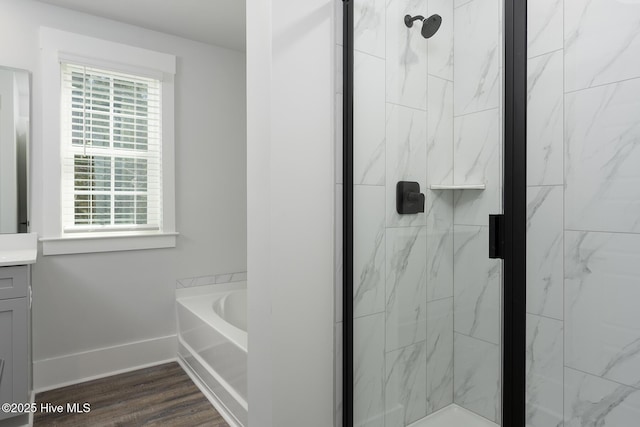 738 Hollybriar Loop Rd SE, Bolivia, NC 28422 - full bathroom with healthy amount of natural light, a marble finish shower, a garden tub, and wood finished floors