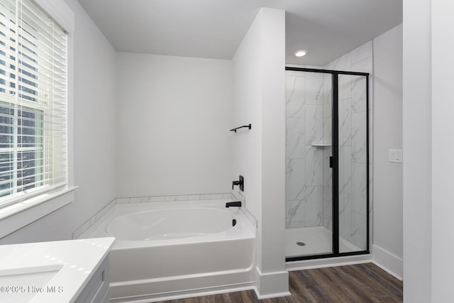 738 Hollybriar Loop Rd SE, Bolivia, NC 28422 - full bathroom with a garden tub, a marble finish shower, wood finished floors, vanity, and baseboards
