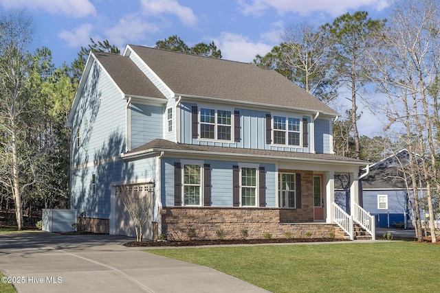 738 Hollybriar Loop Rd SE, Bolivia, NC 28422 - view of front of home featuring an attached garage, driveway, covered porch, a front lawn, and stone siding