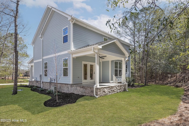 738 Hollybriar Loop Rd SE, Bolivia, NC 28422 - view of side of property featuring french doors, a ceiling fan, and a lawn
