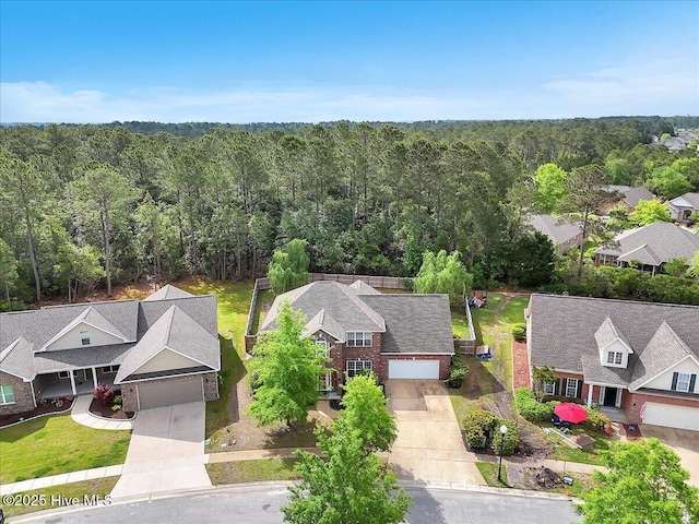 birds eye view of property with a wooded view